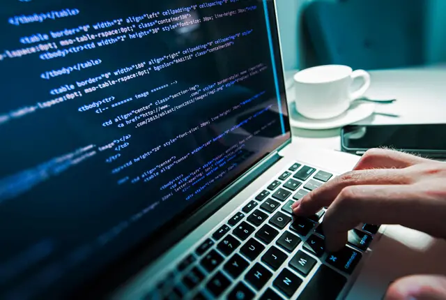 Code on a laptop, illustrating web application development
