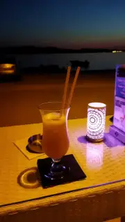 Cocktail and candle in Bellezza night atmosphere